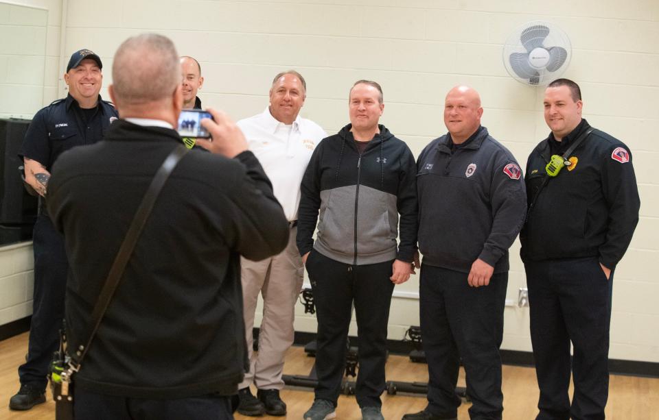Joey Mohr, center, takes photos with some of the Jackson Township first responders who saved his life.