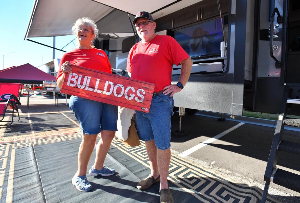 Nancy and Scott Wall from Hawkinsville, Ga., take a break from decorating their RV Tuesday morning in RV City. The Bulldog fans have been setting up camp there for the last 13 years and have been attending the Florida-Georgia games since the late 1980s.
