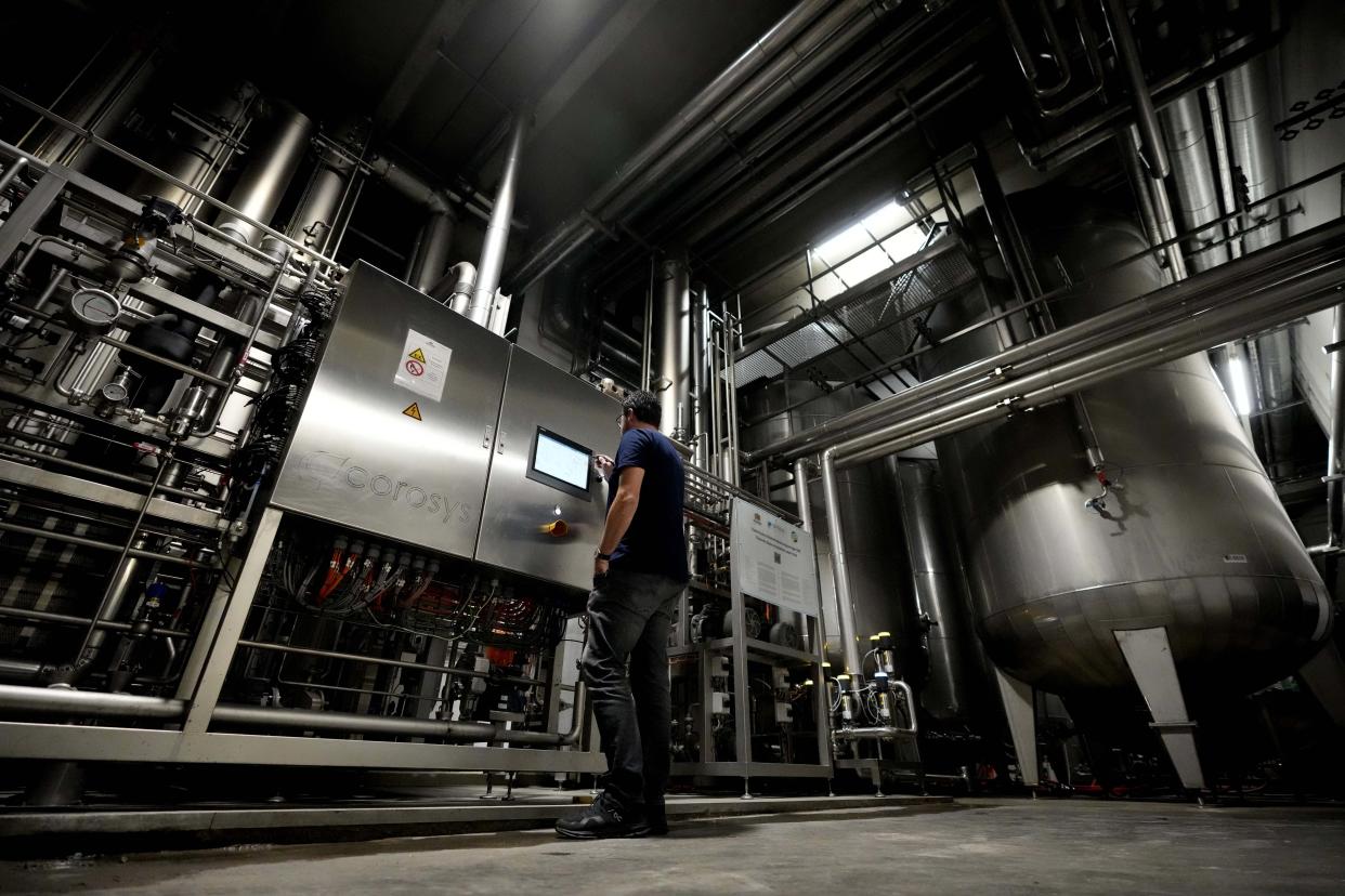 Head Brewmaster Tobias Zollo checks the output at the Weihenstephan brewery in Freising, Germany, Friday, Sept. 20, 2024. (AP Photo/Matthias Schrader)