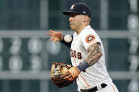 Houston Astros shortstop Carlos Correa loses the ball while fielding a single by Texas Rangers' Willie Calhoun during the sixth inning of a baseball game Tuesday, June 15, 2021, in Houston. (AP Photo/David J. Phillip)