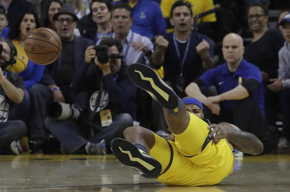 Golden State Warriors center DeMarcus Cousins reacts after falling to the floor during the first half of Game 2 of a first-round NBA basketball playoff series against the Los Angeles Clippers in Oakland, Calif., Monday, April 15, 2019. (AP Photo/Jeff Chiu)