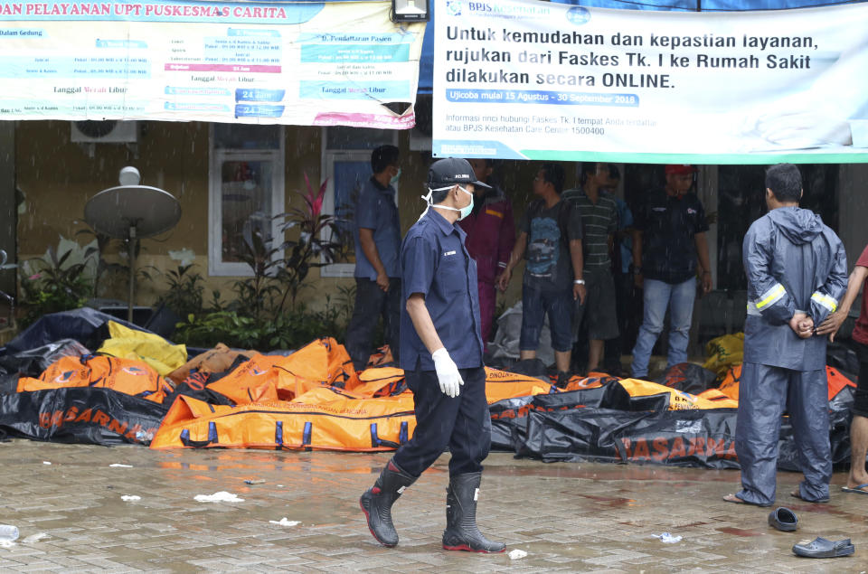 Wrapped bodies of tsunami victims are laid in Carita, Indonesia, Sunday, Dec. 23, 2018. The tsunami occurred after the eruption of a volcano around Indonesia's Sunda Strait during a busy holiday weekend, sending water crashing ashore and sweeping away hotels, hundreds of houses and people attending a beach concert. (AP Photo/Achmad Ibrahim)