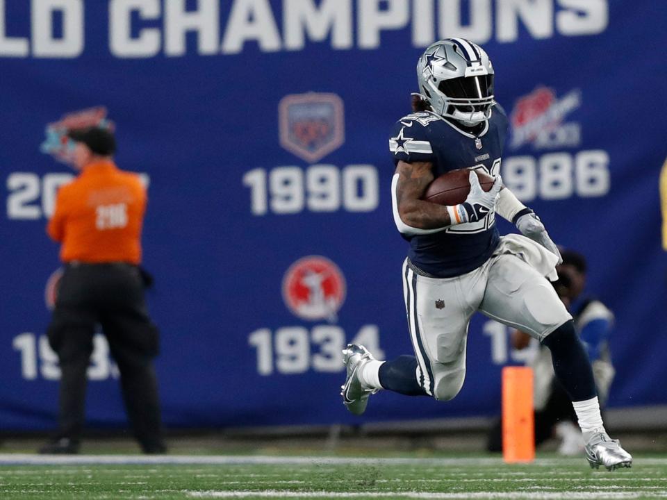 Ezekiel Elliott runs with the ball against the New York Giants.