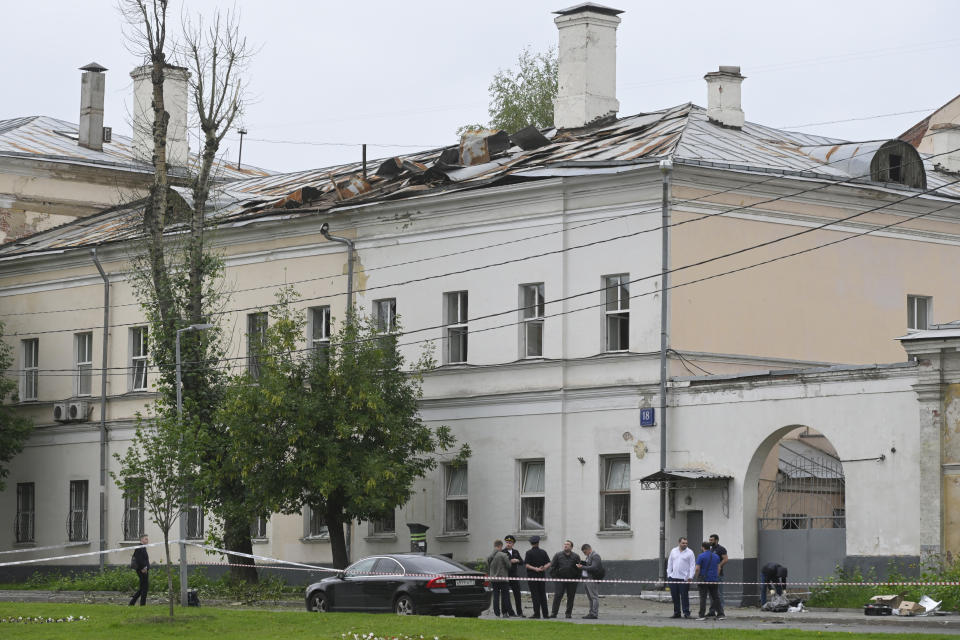 Investigators examine an area next to a damaged building after a reported drone attack in Moscow, Russia, Monday, July 24, 2023. (AP Photo)