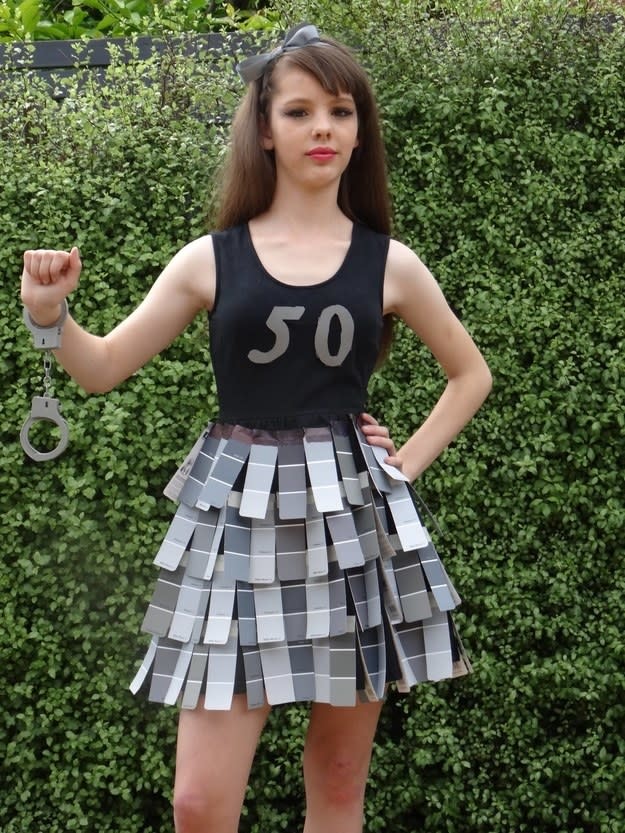 A woman wearing a bunch of gray paint swabs