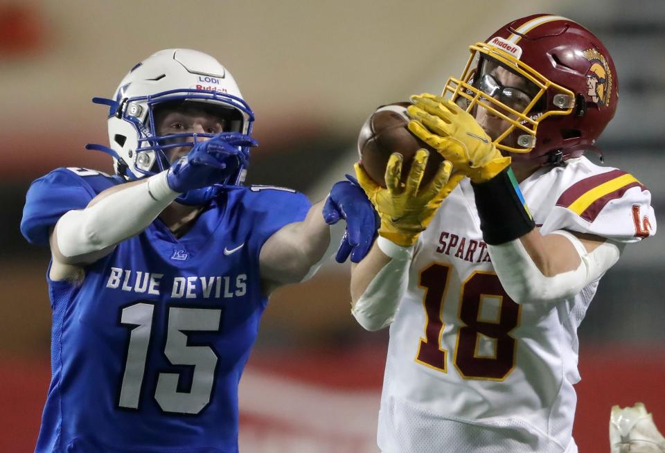 Luxemburg-Casco High School's Braeden Schley (18) catches a pass in front of Lodi High School's Aiden Groskopf (15) during their Division 4 state championship football game on Thursday, November 16, 2023, at Camp Randall Stadium in Madison, Wis. 
Wm. Glasheen USA TODAY NETWORK-Wisconsin