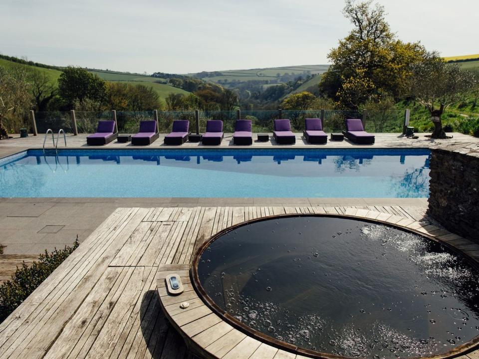 <p>What can we tell you about Oliveta House? This holiday cottage with two pools is the stuff of dreams. It's located in a valley on the outskirts of Dartmouth and has everything swimmers could possibly need. There's an outdoor pool with views (and a hot tub!), plus an indoor one with plush seating and views too. There's a <a href="https://www.womenshealthmag.com/uk/fitness/a32638553/tennis-rules/" rel="nofollow noopener" target="_blank" data-ylk="slk:tennis court;elm:context_link;itc:0;sec:content-canvas" class="link ">tennis court</a> as well, but it's not all about being active here as you'll find a cosy cinema room and a bar for entertaining yourselves. If you're also after a cottage with a steam room, then this exquisite rental has one.</p><p><strong>Sleeps:</strong> 16</p><p><strong>Pets:</strong> No</p><p><strong>Bring:</strong> Walking shoes. The area is stunning and perfect for exploring on long walks.</p><p><strong>Price: </strong>Upon request</p><p><strong>Available from: </strong><a href="https://go.redirectingat.com?id=127X1599956&url=https%3A%2F%2Fwww.sykescottages.co.uk%2Fcottage%2FDevon-Dartmouth%2FOliveta-House-1039546.html&sref=https%3A%2F%2Fwww.womenshealthmag.com%2Fuk%2Ffitness%2Ffitness-holidays%2Fg33559308%2Fcottages-with-pools%2F" rel="nofollow noopener" target="_blank" data-ylk="slk:Sykes Holiday Cottages;elm:context_link;itc:0;sec:content-canvas" class="link ">Sykes Holiday Cottages</a><br></p>