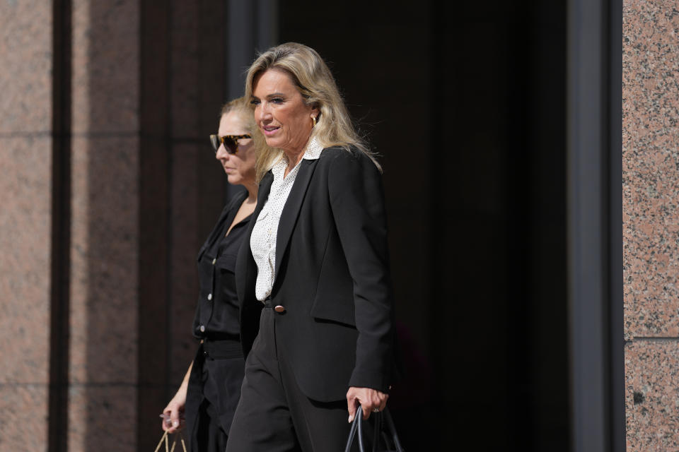 Defense lawyer Jacqueline Arango, right, walks with Karla Wittkop Rocha, wife of Manuel Rocha, are trailed by journalists as they leave the James Lawrence King Federal Justice Building in Miami, Monday, Dec. 4, 2023. Manuel Rocha, 73, a former American diplomat who served as U.S. ambassador to Bolivia, has been charged with serving as a secret agent for Cuba's intelligence services dating back decades, the Justice Department said Monday. (AP Photo/Rebecca Blackwell)