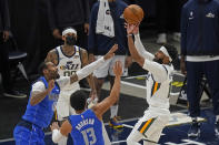 Dallas Mavericks' James Johnson, left, and Jalen Brunson (13) defend as Utah Jazz guard Mike Conley, right, shoots in the first half during an NBA basketball game Wednesday, Jan. 27, 2021, in Salt Lake City. (AP Photo/Rick Bowmer)