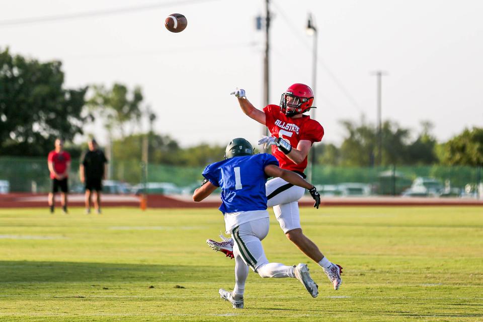 West’s Justin Humphrey (5) throws the ball as East’s Ayden Kemp (1) rushes in during the All State Football game at Oklahoma Baptist University in Shawnee, Okla., on Friday, July 28, 2023.