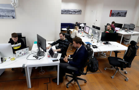 Employees of VP Capital, one of the companies which launched a platform allowing traders to buy shares, gold, foreign exchange and other traditional assets with cryptocurrencies, work at an office in Minsk, Belarus January 15, 2019. REUTERS/Vasily Fedosenko