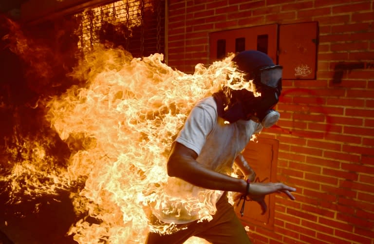 A demonstrator catches fire during clashes with riot police within a protest against Venezuelan President Nicolas Maduro, in Caracas on May 3, 2017