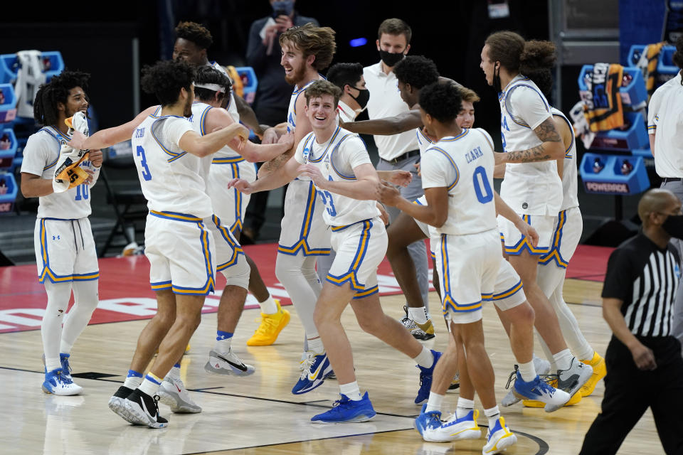 UCLA players celebrate their win over Abilene Christian in a college basketball game in the second round of the NCAA tournament at Bankers Life Fieldhouse in Indianapolis Monday, March 22, 2021. (AP Photo/Mark Humphrey)