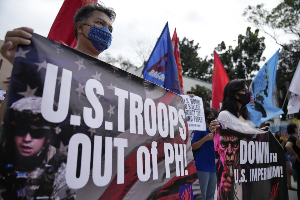 Demonstrators hold banners as they protest against the visit of U.S. Defense Secretary Lloyd Austin outside Camp Aguinaldo military headquarters in metro Manila, Philippines on Thursday, Feb. 2, 2023. Austin is in the Philippines for talks about deploying U.S. forces and weapons in more Philippine military camps to ramp up deterrence against China's increasingly aggressive actions toward Taiwan and in the disputed South China Sea. (AP Photo/Aaron Favila)