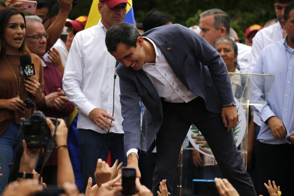 Opposition leader Juan Guaidó greets supporters as he arrives to lead a rally in Caracas, Venezuela, Saturday, May 11, 2019. Guaidó has called for nationwide marches protesting the Maduro government, demanding new elections and the release of jailed opposition lawmakers. (AP Photo/Fernando Llano)