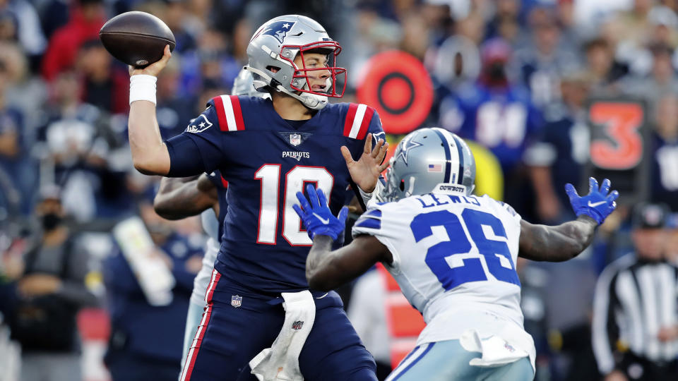 New England Patriots quarterback Mac Jones (10) throws while pressured by Dallas Cowboys cornerback Jourdan Lewis (26) during the first half of an NFL football game, Sunday, Oct. 17, 2021, in Foxborough, Mass. (AP Photo/Michael Dwyer)