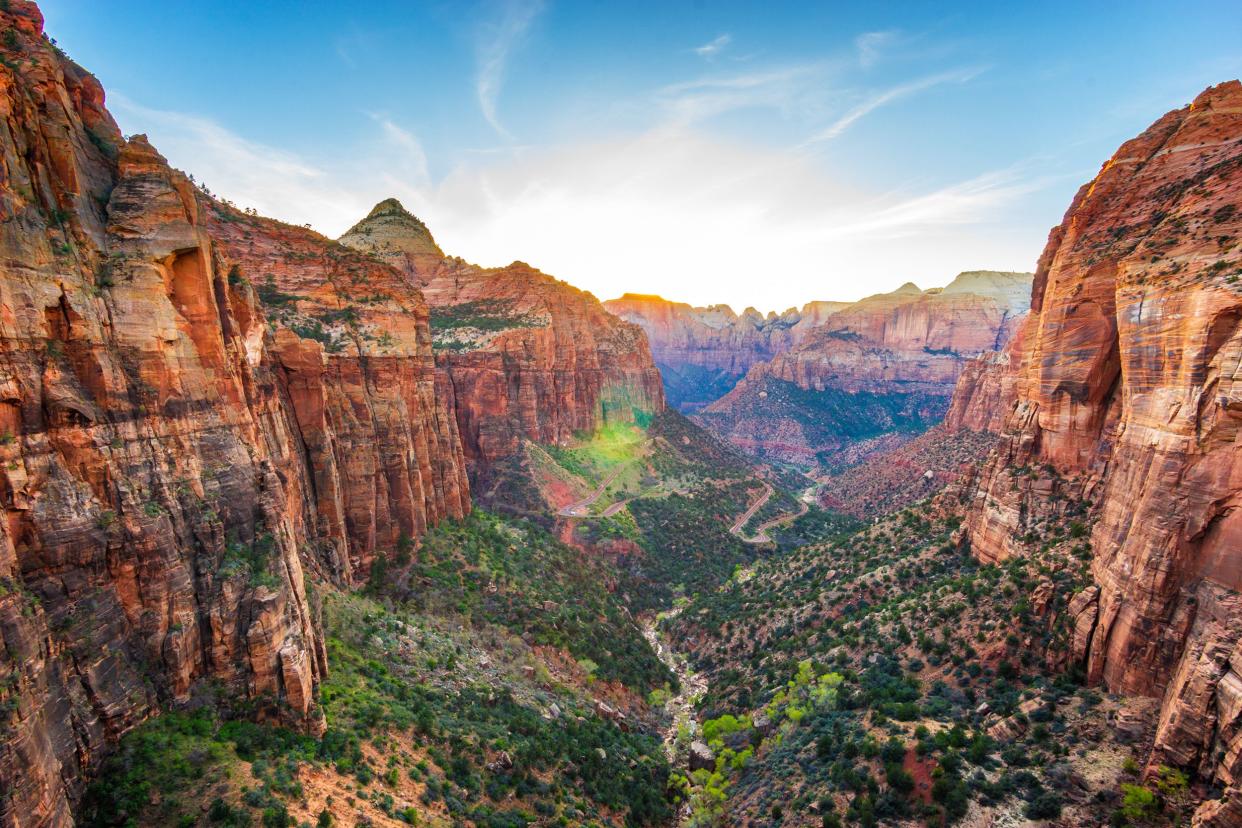 Panoramic View of Zion National Park, Utah, canyons on sides and road in the center
