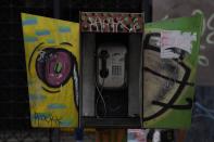 A view of an out of service National Telephone Company of Venezuela, CANTV, phone booth, in Caracas, Venezuela, Friday, May 13, 2022. A number of Venezuelan state-owned companies, including in the telecommunications sector, will sell up to 10% of their shares starting Monday. President Nicolas Maduro says the companies will be listed in the country's stock exchange and the sale is open to local and foreign investors. (AP Photo/Ariana