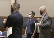 Edgar Samaniego, charged in shooting of Las Vegas police officer, appears in court with his defense attorneys Conor Slife, left, and Scott Coffee at the Regional Justice Center, Friday, June 5, 2020, in Las Vegas. A prosecutor says that a 20-year-old Las Vegas man deliberately shot and gravely wounded a police officer during a Las Vegas Strip protest over the death of George Floyd, who died May 25 after being restrained by police in Minneapolis. (Bizuayehu Tesfaye/Las Vegas Review-Journal via AP)