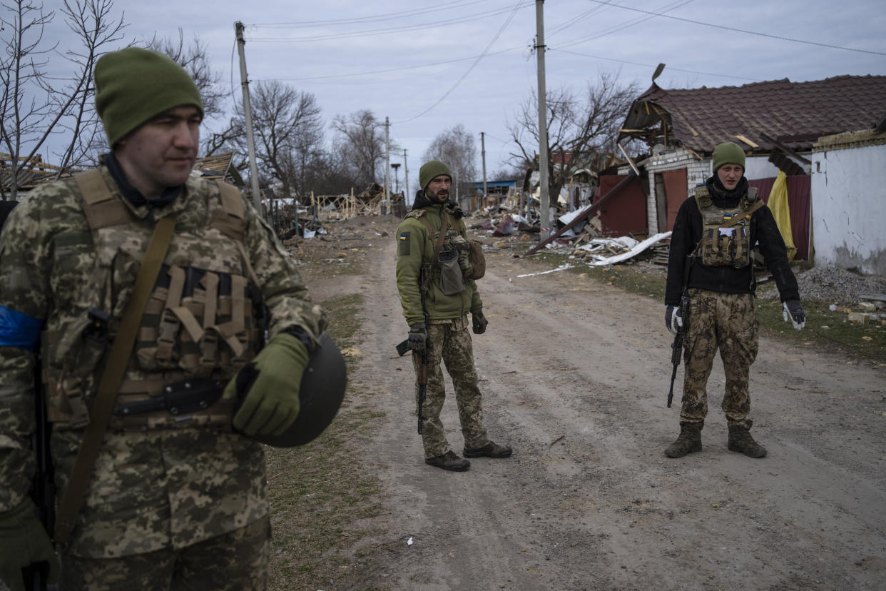Ukrainian soldiers gather near the front line in Brovary, on the outskirts of Kyiv, Ukraine, Monday, March 28, 2022. (AP Photo/Rodrigo Abd)