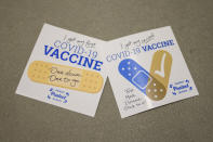 Stickers for the campus community are seen at the Vaccination Site on the campus of Georgia Tech on Thursday, April 8, 2021 in Atlanta. U.S. colleges hoping for a return to normalcy next fall are weighing how far they should go in urging students to get the COVID-19 vaccine, including whether they should — or legally can — require it. (AP Photo/Danny Karnik)