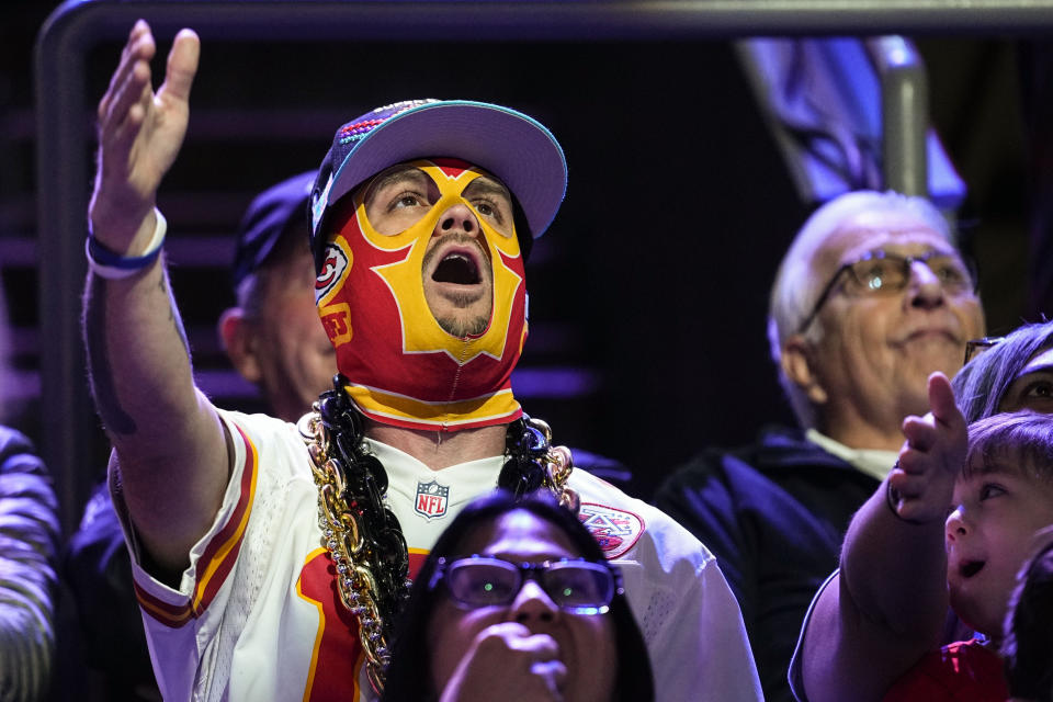 A Kansas City Chiefs fan cheers during the NFL football Super Bowl 57 opening night, Monday, Feb. 6, 2023, in Phoenix. The Kansas City Chiefs will play the Philadelphia Eagles on Sunday. (AP Photo/Matt York)