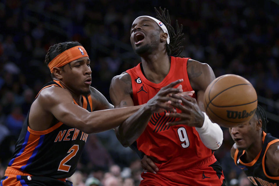 Portland Trail Blazers forward Jerami Grant (9) is fouled by New York Knicks guard Miles McBride during the first half of an NBA basketball game Friday, Nov. 25, 2022, in New York. (AP Photo/Adam Hunger)