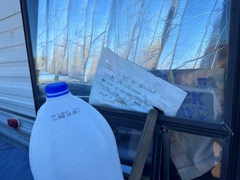 A note left for Bureau of Land Management rangers reads, "This is not an abanded vehicle. We will move it as soon as we can." The camper is one of dozens parked on federal land near Apache Junction in Pinal County.