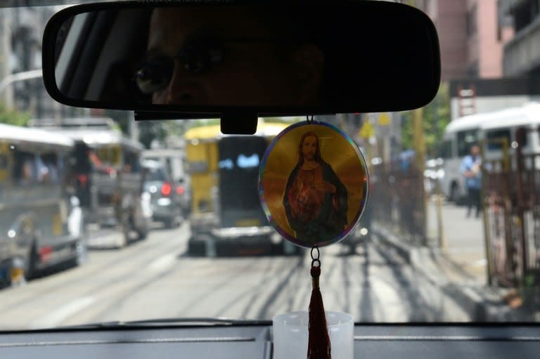 A Filipino taxi driver displays a religious icon inside his vehicle in Manila