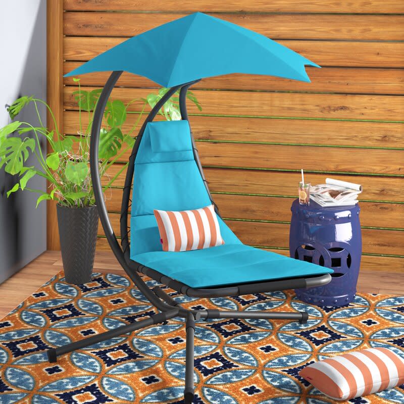 Maglione Hanging Chaise Lounger with Stand. Image via Wayfair.