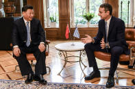 Greece's Prime Minister Kyriakos Mitsotakis, right, talks with China's President Xi Jinping, left, prior to their meeting at Maximos Mansion in Athens, Monday, Nov. 11, 2019. Xi Jinping is in Greece on a two-day official visit. (Aris Messinis/Pool via AP)