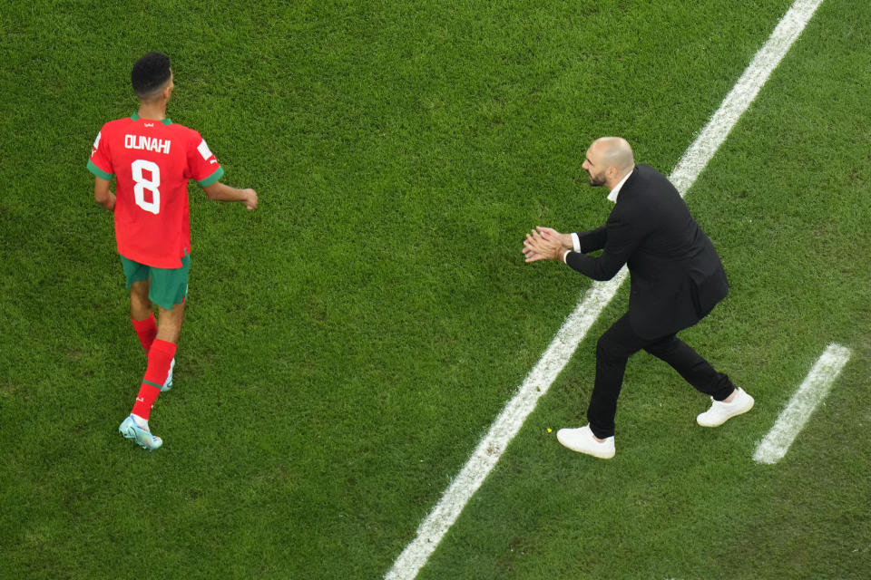 Morocco's head coach Walid Regragui, right, gestures to Morocco's Azzedine Ounahi during the World Cup round of 16 soccer match between Morocco and Spain, at the Education City Stadium in Al Rayyan, Qatar, Tuesday, Dec. 6, 2022. (AP Photo/Petr David Josek)