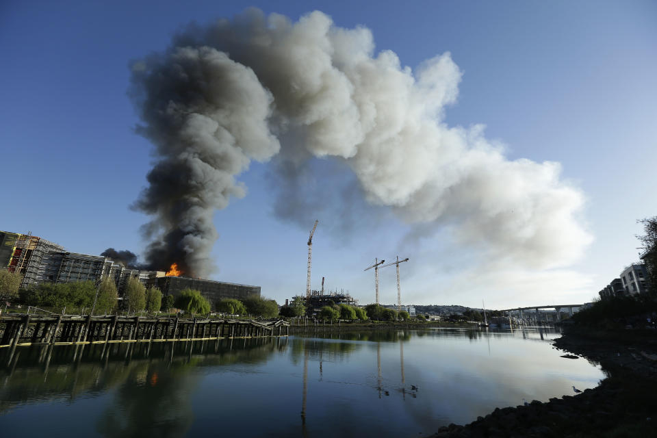 Smoke rises from a fire burning in San Francisco, Tuesday, March 11, 2014. (AP Photo/Jeff Chiu)