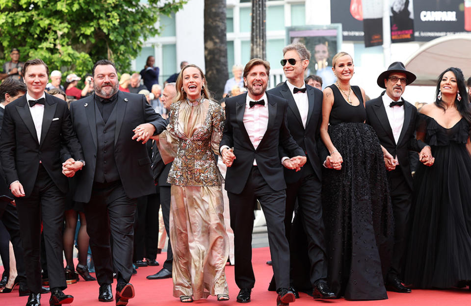 (L to R) Members of the Jury Paul Dano, Denis Ménochet, Brie Larson, President of the Jury Ruben Östlund, Damian Szifron, Julia Ducournau, Atiq Rahimi and Maryam Touzani