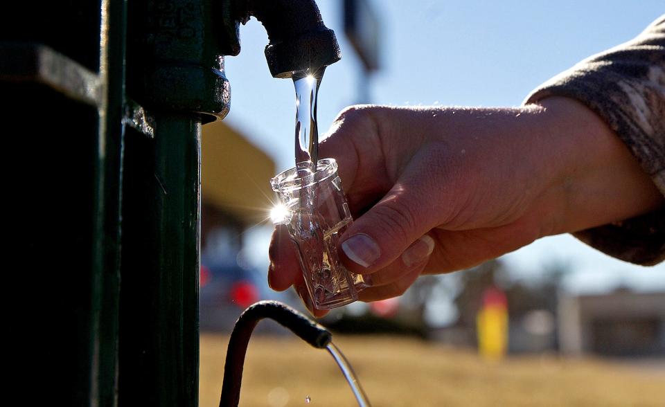 Courtney Lemons with the city of San Angelo takes a water sample at a testing station on Knickerbocker Rd. on Monday, Feb. 22, 2021.