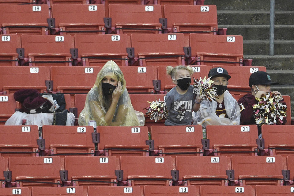 LANDOVER, MARYLAND - OCTOBER 11: Elizabeth Smith, wife of Alex Smith #11 of the Washington Football Team, and their children watch the second half during a game against the Los Angeles Rams at FedExField on October 11, 2020 in Landover, Maryland. Smith played in his first game since being injured during a game against the Houston Texans on November 18, 2018. (Photo by Patrick McDermott/Getty Images)