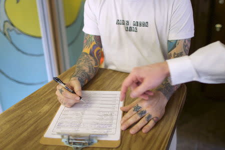 Russ Iglay prepares to sign an election petition for James Keady, who is running as a Democrat for New Jersey Assembly, in Belmar, New Jersey March 28, 2015. REUTERS/Mark Makela