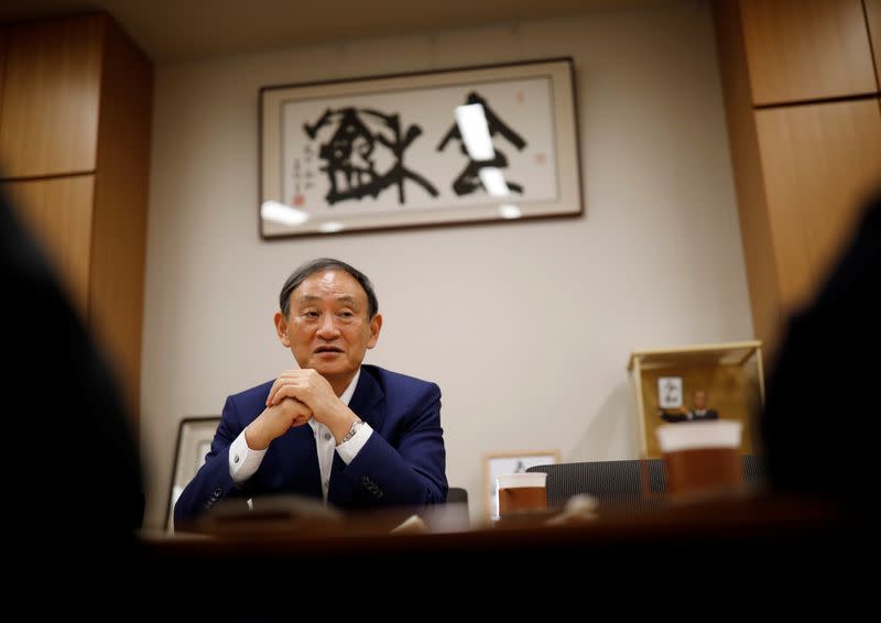 Japan's top government spokesman Chief Cabinet Secretary Yoshihide Suga speaks during an interview with Reuters in Tokyo