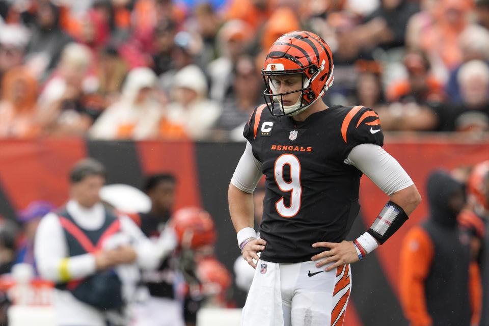 Cincinnati Bengals quarterback Joe Burrow (9) pauses between plays during the first half of an NFL football game against the Pittsburgh Steelers, Sunday, Sept. 11, 2022, in Cincinnati. (AP Photo/Jeff Dean)