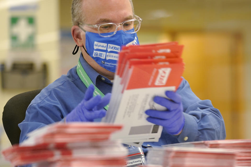 An election worker sorts mailed-in ballots at the King County Elections office Tuesday, Nov. 3, 2020, in Renton, Wash. (AP Photo/Ted S. Warren)