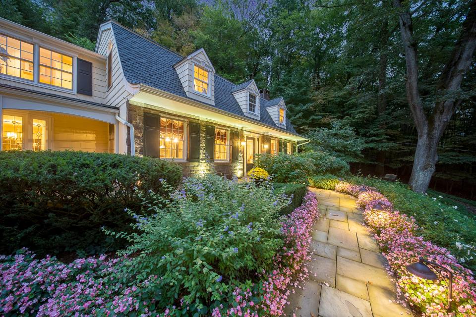 The expanded 1950s colonial at 26 East Saddle River Road was once the home of Paul Hadley Bell, a leading biochemist for the former American Cyanamid Company. The home in 2023 features lush gardens cultivated by its most recent owner.