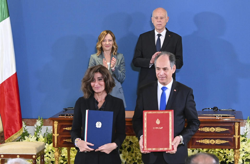 In this photo provided by the Tunisian Presidency, Tunisian President Kais Saied, rear right, and Italian Prime Minister Giorgia Meloni, applaud after the signing of an agreement by Anna Maria Bernini Minister of University and Research, left, and her Tunisian counterpart Moncef Boukthir in Tunis, Wednesday April 17, 2024. Meloni and Saied signed new accords part of Italy's larger "Mattei Plan" for Africa, a continent-wide strategy aimed at growing economic opportunities and preventing migration from Africa to Europe. (Slim Abid/ Tunisian Presidential Palace via AP)