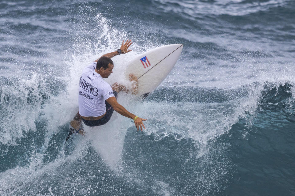 Brian Toth from Puerto Rico competes in the ISA World Surfing Games, a qualifier for the Paris 2024 Olympic Games, off La Marginal beach in Arecibo, Puerto Rico, Wednesday, Feb. 28, 2024. (AP Photo/Alejandro Granadillo)