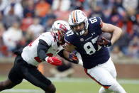 Auburn tight end Brandon Frazier (87) carries the ball as Western Kentucky linebacker Derrick Smith, left, tackles him during the first half of an NCAA college football game Saturday, Nov. 19, 2022, in Auburn, Ala. (AP Photo/Butch Dill)