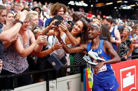 Britain Athletics - 2016 London Anniversary Games - Queen Elizabeth Olympic Park, Stratford, London - 23/7/16 Great Britain's Mo Farah poses for a selfie with spectators as he celebrates winning the men's 5000m Reuters / Eddie Keogh Livepic