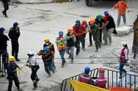 Volunteers remove rubble from a quake-flattened building in Mexico City