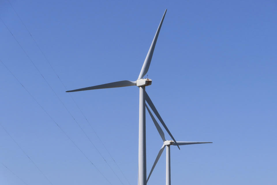 Land-based wind turbines spin in Atlantic City N.J. on April 28, 2022. A report issued March 29, 2023 by two federal marine science agencies and the commercial fishing industry highlighted several potential negative aspects of offshore wind energy development on the fishing industry and called for additional research. (AP Photo/Wayne Parry)