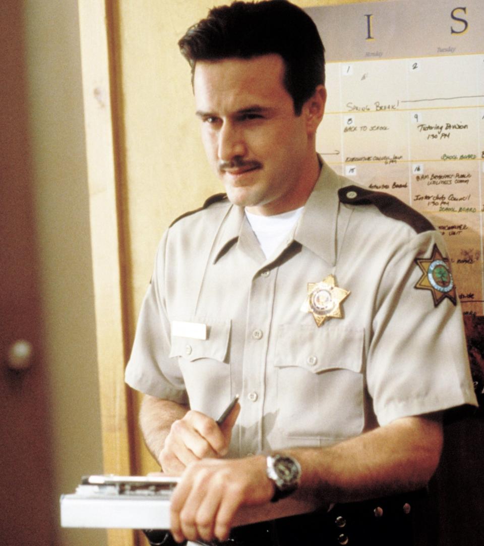 Deputy Dewey in uniform standing in the sheriff's office
