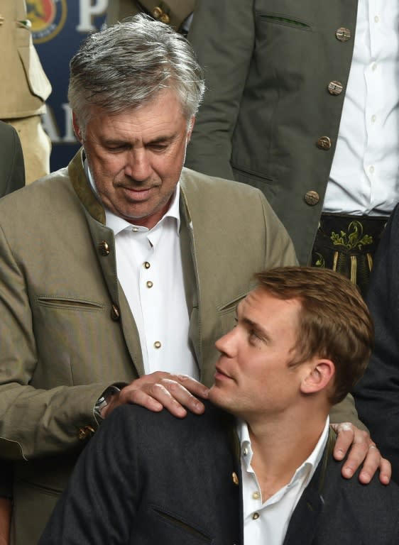 Bayern Munich's head coach Carlo Ancelotti and goalkeeper Manuel Neuer pose in traditional Bavarian clothes on the set of a beer advertising photo shoot in Munich, southern Germany, on September 14, 2016