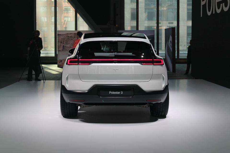 The rear of a white Polestar 3 electric SUV, with tall windows in the background.